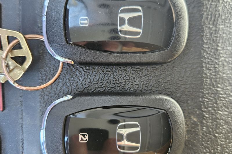 Two new Honda smart key fobs laid out ready for programming.